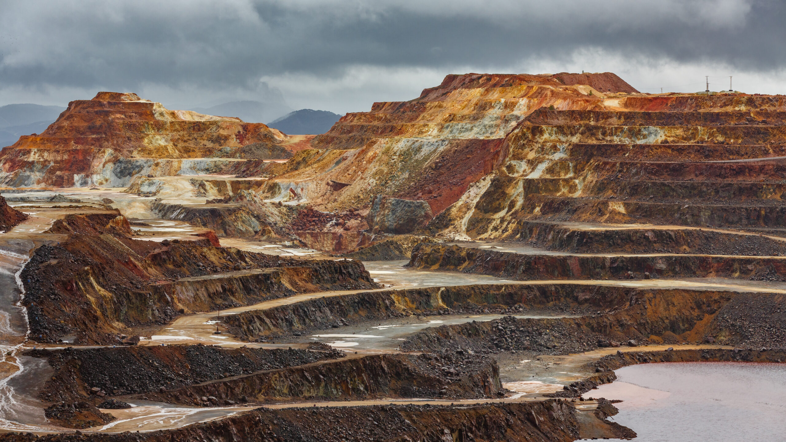 Detailed view of copper mine open pit with storm clouds above