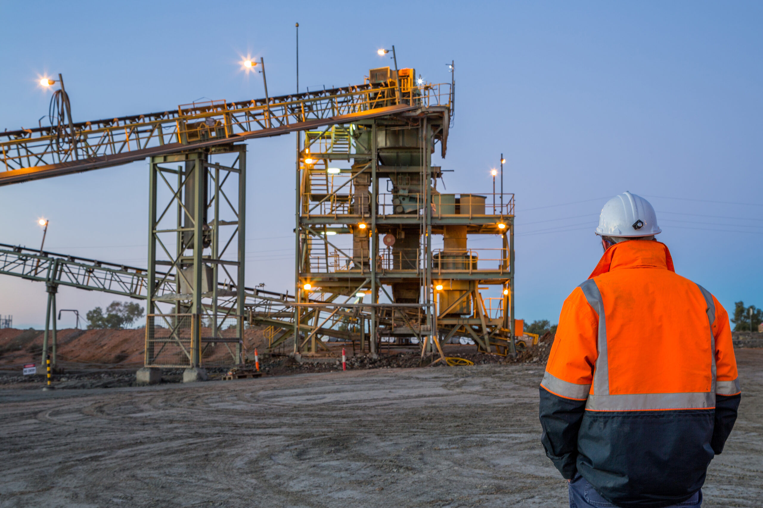 SysEne consultant standing off in a distance looking at a mining operation.