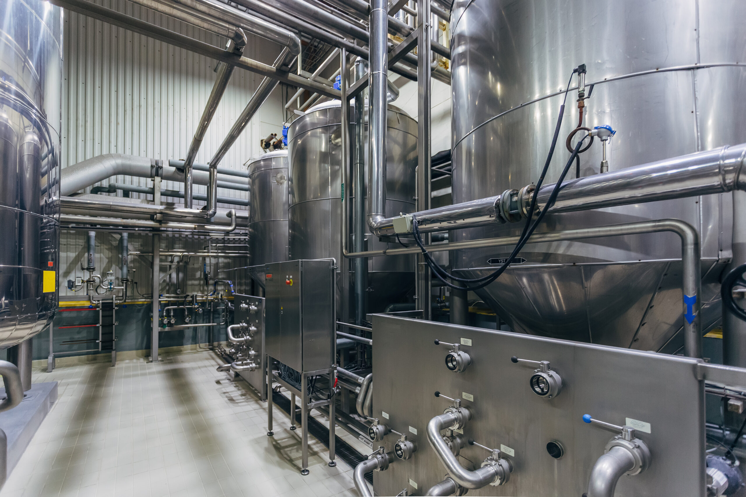 Industrial stainless steel vats in modern brewery