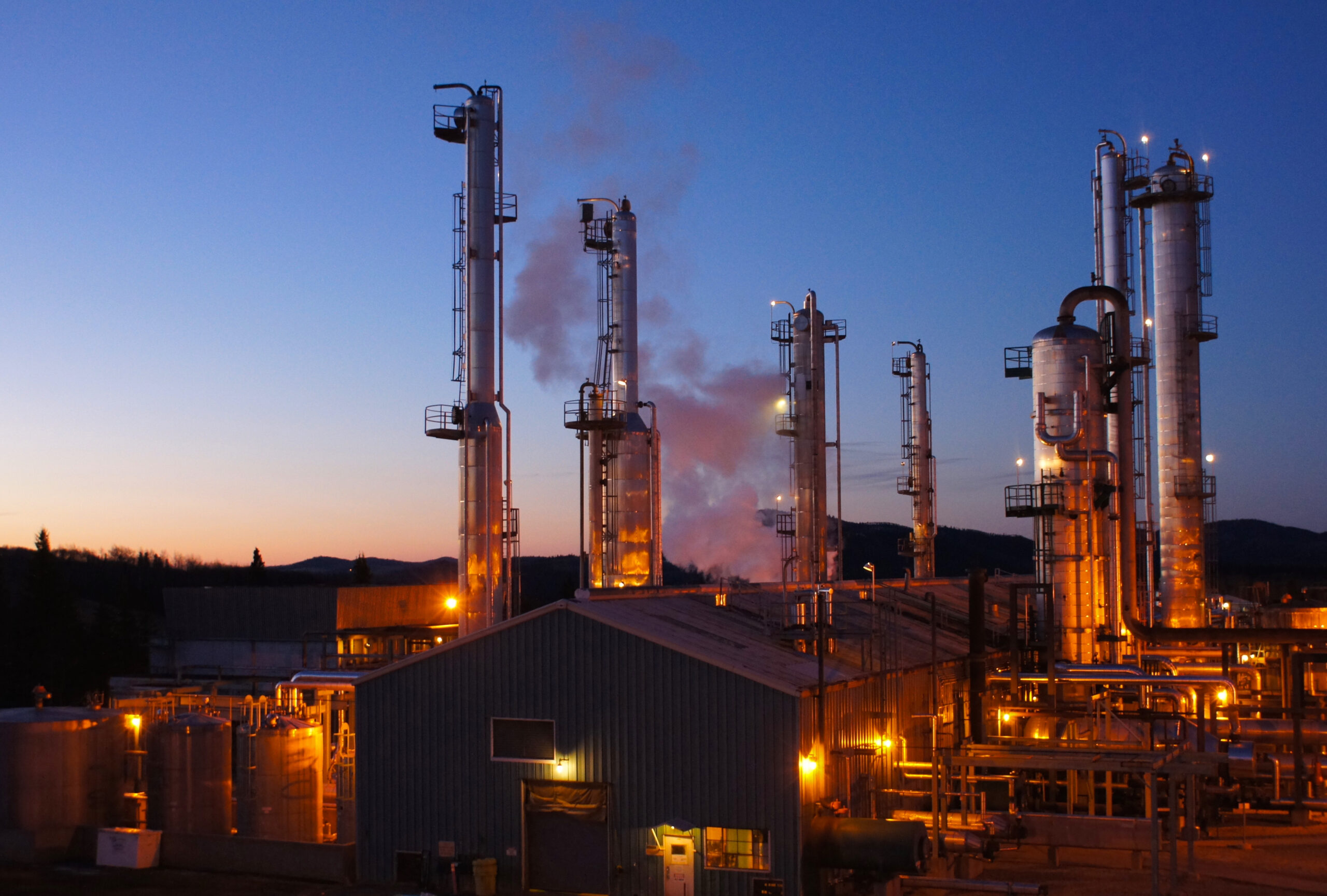 oil and gas facility at dusk