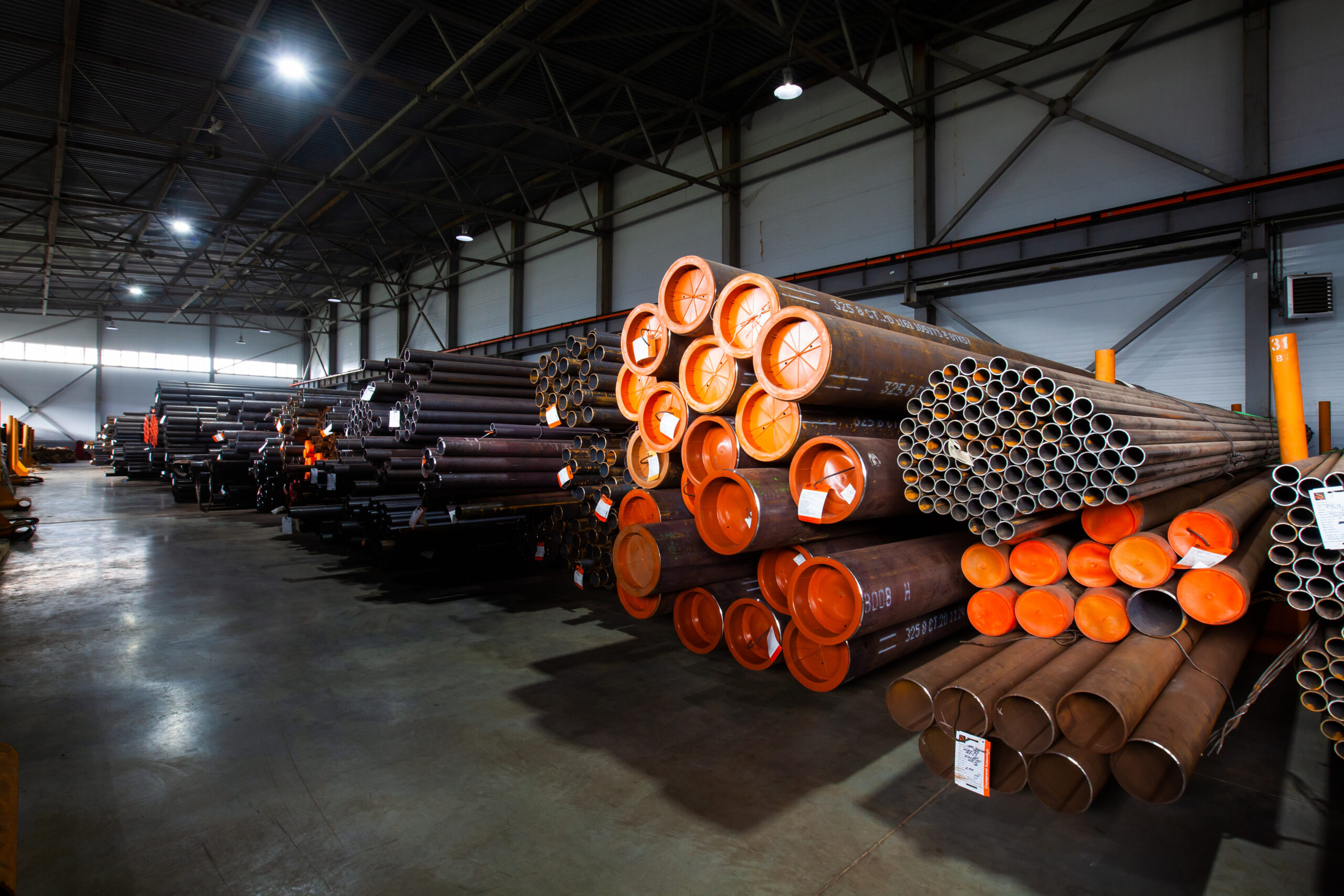 Pipes and tubes warehouse in metal hangar